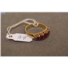 Image 1 : Lady's 14kt yellow gold and channel set ruby ring. Set with 1.00 ct of oval cut natural rubies. Reta