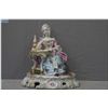 Image 1 : A vintage Dresden figurine of a figure in Rococo dress seated at a table reading complete with hand 