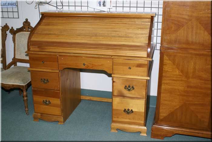 A Seven Drawer Roll Top Desk With Interior Locking Drawer