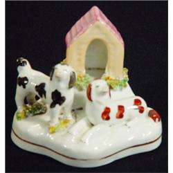 Early 19th century Staffordshire porcelaineous dog group with a standing black and white patched …