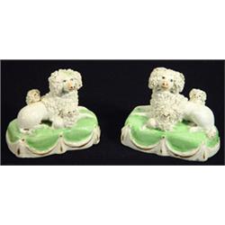 Pair of early 19th century Staffordshire poodle groups of mother and her two babies seated on gre…