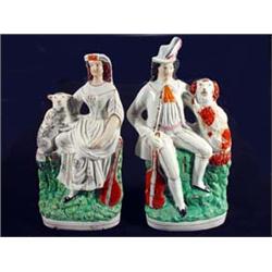 Pair of hand painted Victorian Staffordshire figure groups of a seated man with a dog and a guita…