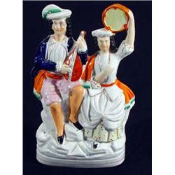 Hand painted Victorian Staffordshire figure group of a gentleman playing a lute and woman with a …