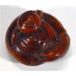 Signed oriental wooden Netsuke of a curled up snail…