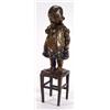 Image 1 : Bronze model of a young girl with finger in her mouth holding a boot standing on a rush stool, si…