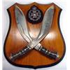 Pair of crossed horn handled Gurkha knives and a silver Gurkha badge mounted onto wooden shield…