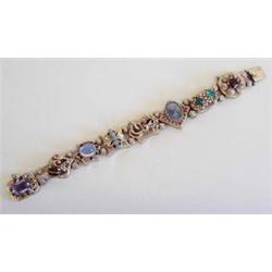 FOURTEEN KARAT YELLOW GOLD SLIDE BRACELET Composed of eight assorted slides, each of different sh...