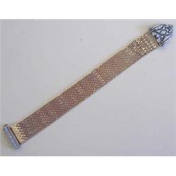 PLATINUM, YELLOW GOLD AND DIAMOND BRACELET Composed of fourteen karat gold "brickwork" links, dec...