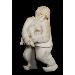 Marine Ivory Carving of an Inuk Holding a Pup - Inuit Greenland Culture ca. 1940's 4 1/2" H. 2 1/4" 