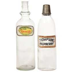 Soda fountain syrup bottles (2), John Graf Co. Lemon Life (no lid) & Thompson's Raspberry, both labe