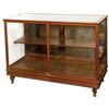 Image 1 : Showcase, oak floor model w/fancy cast iron feet, beveled glass top, oak shelf & sliding doors at re