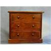 Image 1 : A Victorian walnutwood "apprentice" chest of 3 long drawers with tore handles, raised on a platfo...