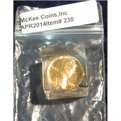230. 1964 Gold Plated Lincoln Cent encapsulated in a lucite cube. Originally used in a coin flipping