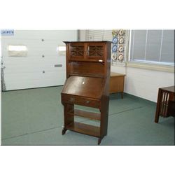 Quarter cut oak antique Mission style drop front desk with lower book storage and two door galley