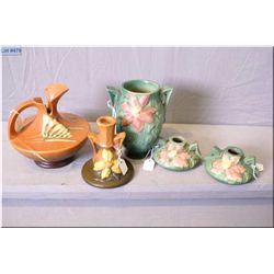 Five pieces of Roseville Pottery including Clematis candle holders and double handled vases, a candl