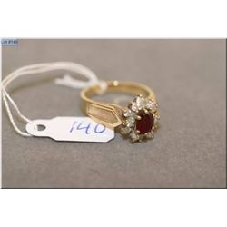 Lady's 14kt yellow gold, ruby and diamond cluster dinner ring set with 0.63ct natural ruby and accen