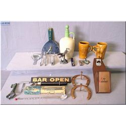 A selection of bar collectibles including stoneware gin bottle, putty knife clock, corkscrews, horse