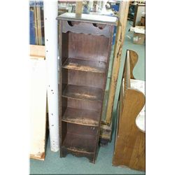 A narrow primitive four tier what-not shelf