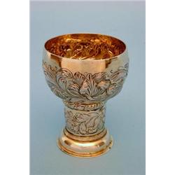 A German silver gilt wedding cup, circa 1700, the ovoid bowl with repousse decoration of flowers...