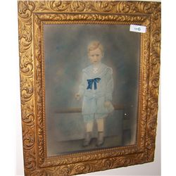 ANTIQUE HAND COLORED PHOTOGRAPH OF A YOUNG BOY IN A BLUE SUIT, IN AN ORNATE FRAME