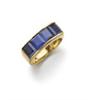Image 1 : A GOLD AND SAPPHIRE RING Channel-set with four calibre-cut sapphires, mounted in 18K gold, size 8...