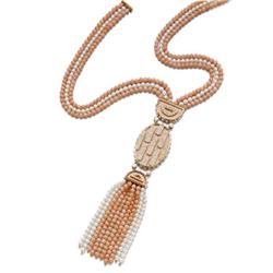 CARTIER A CORAL AND CULTURED PEARL NECKLACE Designed as a gold oval plaque with coral ground enha...