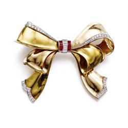 A GOLD, RUBY AND DIAMOND BOW BROOCH The two-toned gold bow enhanced with circular-cut diamond edg...
