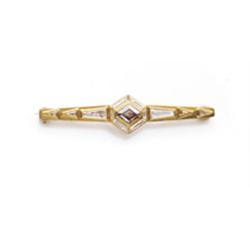 CARTIER A GOLD, COLORED DIAMOND AND DIAMOND BAR BROOCH Centering upon a lozenge-shaped brown diam...
