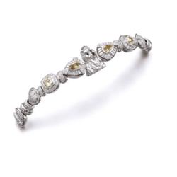 Jewels from a Private Collection A WHITE GOLD, COLORED DIAMOND AND DIAMOND BRACELET The front des...