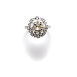 A DIAMOND RING The brilliant-cut diamond weighing 4.56 carats within a surround of similarly cut ...