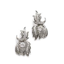 A PAIR OF DIAMOND EARCLIPS Each of leaf and trellis-work design, centering upon a cushion-shaped ...