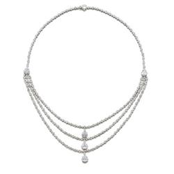 A DIAMOND NECKLACE The front, designed as three rows set with rose and circular-cut diamonds, eac...