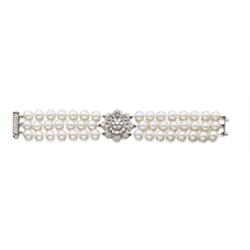 A CULTURED PEARL AND DIAMOND BRACELET Designed as three rows of cultured pearls and centering upo...