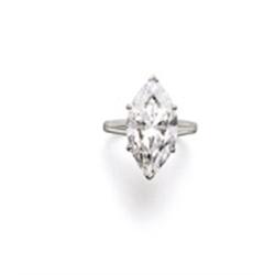 A DIAMOND RING The marquise-shaped diamond weighing 11.76 carats to the tapered baguette-cut diam...
