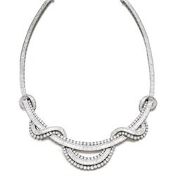 A DIAMOND NECKLACE The front designed as an undulating line set with baguette and brilliant-cut d...