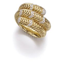 BULGARI A GOLD AND DIAMOND "SPIGA" BRACELET The 18K gold flexible band designed as a series of ch...