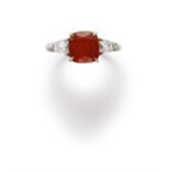 A FINE RUBY AND DIAMOND RING The antique cushion-cut ruby weighing 3.61 carats to the tapered bag...
