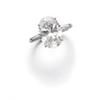 Image 1 : A DIAMOND RING The oval-shaped diamond weighing 5.71 carats to the tapered baguette-cut diamond s...