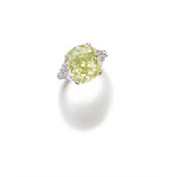A RARE AND ATTRACTIVE FANCY YELLOW-GREEN DIAMOND RING The fancy yellow-green cushion-shaped diamo...