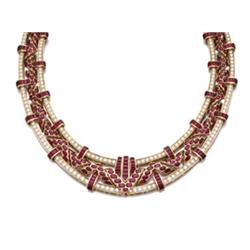 A RUBY AND DIAMOND NECKLACE Designed as an openwork band with graduated oval-cut ruby chevrons an...