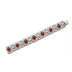 AN ART DECO RUBY AND DIAMOND BRACELET Designed as a series of shaped rectangular openwork plaques...