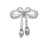Image 1 : A BELLE EPOQUE DIAMOND AND NATURAL PEARL BROOCH Designed as a ribbon bow set with old mine, rose ...