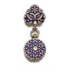 AN ANTIQUE DIAMOND AND ENAMEL LAPEL WATCH The circular-shaped white enamel dial with blue painted...