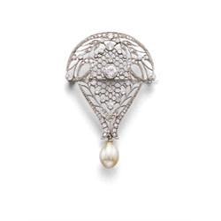 A BELLE EPOQUE PLATINUM, DIAMOND AND NATURAL PEARL BROOCH The scroll plaque of pierced and honey-...