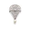 Image 1 : A BELLE EPOQUE PLATINUM, DIAMOND AND NATURAL PEARL BROOCH The scroll plaque of pierced and honey-...