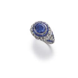 AN ART DECO SAPPHIRE AND DIAMOND RING Of pierced design, the oval-shaped sapphire weighing approx...