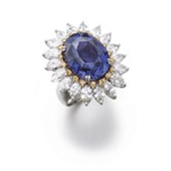 AN UNUSUAL COLOR CHANGE SAPPHIRE, DIAMOND AND YELLOW DIAMOND RING The oval-shaped color change sa...