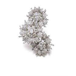 From a European estate AN ART DECO DIAMOND CLIP BROOCH Designed as three flowerheads, set with ol...