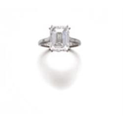 A SINGLE STONE DIAMOND RING The rectangular-cut diamond weighing 5.41 carats to the platinum hoop...