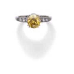 A FANCY VIVID ORANGY YELLOW DIAMOND RING The fancy vivid orangy yellow brilliant-cut diamond weig...